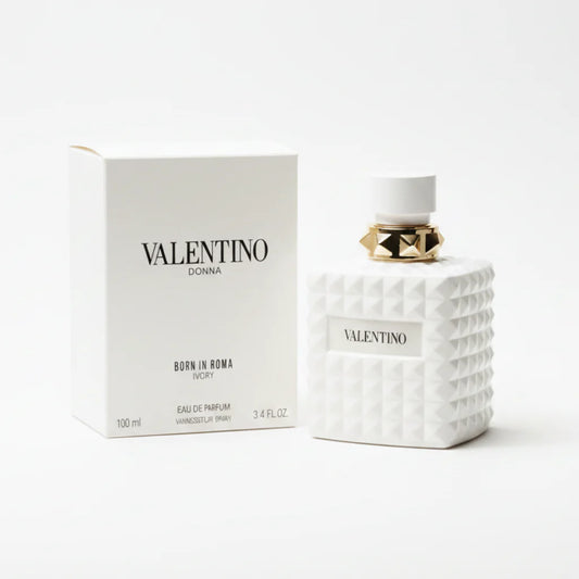 Valentino perfume bottle and packaging on a marble surface with a dark background